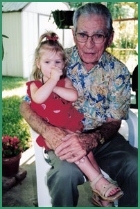 Eugene Guckian, 81, holds a great-granddaughter, Soleil
